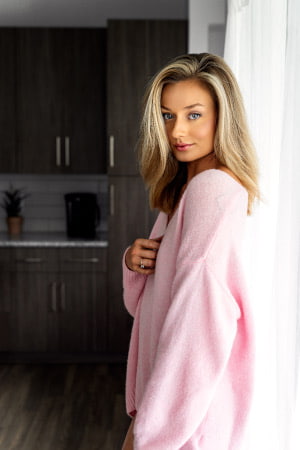 Blonde Italian girl in a pink top smiling sweetly