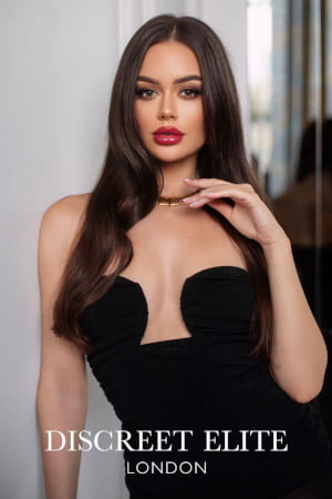 A natural and young pretty Russian brunette girl in a designer black dress