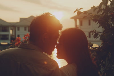 A young couple about to kiss in the sunset light